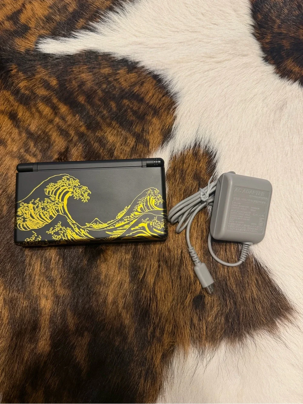Nintendo Black Handheld Console with Yellow Wave Art
